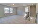 This bonus room features two windows for ample light and beige carpet at 108 Dalston Cv, Stockbridge, GA 30281