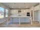 Kitchen featuring white cabinets, quartz countertops, stainless appliances and island with seating at 108 Dalston Cv, Stockbridge, GA 30281