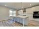 New kitchen featuring white cabinets, quartz countertops, stainless appliances and oversized island with sink at 108 Dalston Cv, Stockbridge, GA 30281