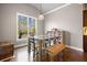 Bright dining room features a rustic table, built-in shelving, and hardwood floors at 121 Harmony Oaks Trl, Canton, GA 30115