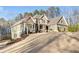 Two-story house with attached garage, stone accents and landscaping at 121 Harmony Oaks Trl, Canton, GA 30115