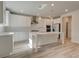 Modern kitchen features white cabinets, center island, and stainless steel appliances at 205 Chiswick Loop, Stockbridge, GA 30281