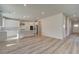 Open concept kitchen with white cabinets, large island, and stainless steel appliances at 205 Chiswick Loop, Stockbridge, GA 30281