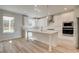 Open concept kitchen with white cabinets, large island, and stainless steel appliances at 205 Chiswick Loop, Stockbridge, GA 30281