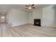 Bright living room features hardwood floors and a fireplace at 205 Chiswick Loop, Stockbridge, GA 30281