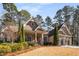 Brick home with a three-car garage and nicely landscaped yard at 5905 Kayron Dr, Atlanta, GA 30328