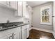 Laundry room with white cabinets, granite countertop, and window at 5905 Kayron Dr, Atlanta, GA 30328