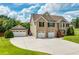 Brick house with 3-car garage and landscaped lawn at 981 Golden Meadows Ln, Loganville, GA 30052