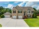 Brick house with 3-car garage and landscaped lawn at 981 Golden Meadows Ln, Loganville, GA 30052