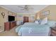 Spacious main bedroom with ceiling fan, large TV and ample closet space at 110 Wiley Bridge Ct, Woodstock, GA 30188