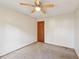 Simple bedroom with ceiling fan and wood door at 1482 Kings Ridge Dr, Norcross, GA 30093