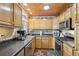 L-shaped kitchen with dark countertops and stainless steel appliances at 181 Long Dr, Marietta, GA 30060