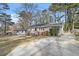 Ranch home with driveway, landscaping, and mature trees at 2591 Connally Dr, Atlanta, GA 30344