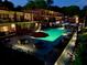 Relaxing pool area at night with patio furniture and umbrellas at 1705 Monroe Ne Dr # B05, Atlanta, GA 30324