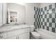 Bathroom with white vanity, marble countertop and green tile shower at 2675 S Bamby Ne Ln, Brookhaven, GA 30319