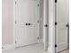 White paneled closet doors with black hardware at 2675 S Bamby Ne Ln, Brookhaven, GA 30319