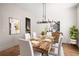 Modern farmhouse dining room with wood flooring, large chandelier, and built-in wall detail at 2675 S Bamby Ne Ln, Brookhaven, GA 30319