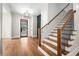 Elegant entryway with hardwood floors, modern staircase, and a view to the living area at 2675 S Bamby Ne Ln, Brookhaven, GA 30319