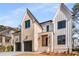 Modern farmhouse style home with a three car garage and beautiful landscaping at 2675 S Bamby Ne Ln, Brookhaven, GA 30319