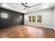 Main bedroom with hardwood floors and dark accent wall at 2675 S Bamby Ne Ln, Brookhaven, GA 30319