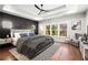 Main bedroom with hardwood floors, a ceiling fan and large windows at 2675 S Bamby Ne Ln, Brookhaven, GA 30319