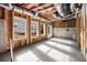 Unfinished basement with three windows and concrete floors at 2675 S Bamby Ne Ln, Brookhaven, GA 30319