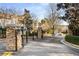 Gated community entrance with stone pillars and black wrought iron gates at 3047 Lenox Ne Rd # 1108, Atlanta, GA 30324