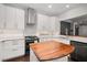 White kitchen with stainless steel appliances and a wood center island at 3047 Lenox Ne Rd # 1108, Atlanta, GA 30324