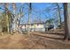 House backyard with mature trees and a deck at 409 Katherine Ln, Woodstock, GA 30189