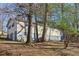 House backyard with mature trees and a partial view at 409 Katherine Ln, Woodstock, GA 30189