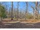 Large backyard with mature trees and ample space for recreation at 409 Katherine Ln, Woodstock, GA 30189