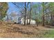 House backyard with mature trees and a sloped yard at 409 Katherine Ln, Woodstock, GA 30189