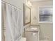 Bathroom featuring granite countertop, white vanity, and a mirror at 409 Katherine Ln, Woodstock, GA 30189