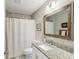 Updated bathroom with granite countertop, white vanity, and a shower/tub combo at 409 Katherine Ln, Woodstock, GA 30189