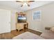 Bright bedroom with hardwood floors and a home office setup at 409 Katherine Ln, Woodstock, GA 30189