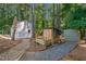 Landscaped backyard with sheds and a brick pathway at 436 Suwanee East Dr, Lawrenceville, GA 30043