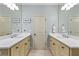 Clean bathroom featuring double sinks and light color scheme at 9032 Selborne Ln, Chattahoochee Hills, GA 30268