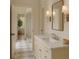 Bright bathroom with marble counters, modern fixtures, and a glass-enclosed shower in an elegant design at 9032 Selborne Ln, Chattahoochee Hills, GA 30268