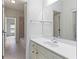 Neutral bathroom features a large mirror, vanity with chrome fixtures, and a shower-tub combo for functionality at 9032 Selborne Ln, Chattahoochee Hills, GA 30268