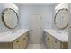 Elegant bathroom with dual vanities and large mirrors at 9032 Selborne Ln, Chattahoochee Hills, GA 30268