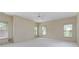 Bright bedroom featuring neutral tones, carpeted floors, and multiple windows with blinds allowing plenty of natural light at 9032 Selborne Ln, Chattahoochee Hills, GA 30268