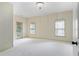 Spacious bedroom featuring neutral tones, carpeted floors, and a private balcony at 9032 Selborne Ln, Chattahoochee Hills, GA 30268