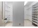Walk-in closet with adjustable shelving and ample storage space at 9032 Selborne Ln, Chattahoochee Hills, GA 30268