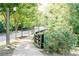 Paved walkway with trees and wooden fence at 9032 Selborne Ln, Chattahoochee Hills, GA 30268