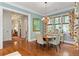 Charming dining room with hardwood floors, floral curtains, and a round wooden table at 9032 Selborne Ln, Chattahoochee Hills, GA 30268