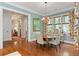 Charming dining room with hardwood floors, decorative chandelier and windows with patterned curtains at 9032 Selborne Ln, Chattahoochee Hills, GA 30268