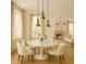 Elegant dining room with modern lighting, marble table, and neutral decor at 9032 Selborne Ln, Chattahoochee Hills, GA 30268