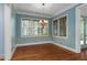 Inviting dining room with hardwood floors, modern chandelier, and natural light at 9032 Selborne Ln, Chattahoochee Hills, GA 30268