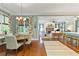 Bright dining room with hardwood floors and view into the living area at 9032 Selborne Ln, Chattahoochee Hills, GA 30268