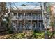 Charming two-story home featuring dual covered porches and stone accents at 9032 Selborne Ln, Chattahoochee Hills, GA 30268